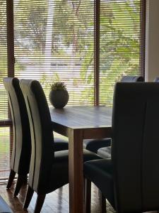a dining room table with chairs and a plant on it at Humble & Homely in Rockingham