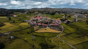 an aerial view of a village in a field at Refúgio Nariz do Mundo (Casa do Meio) in Cabeceiras de Basto
