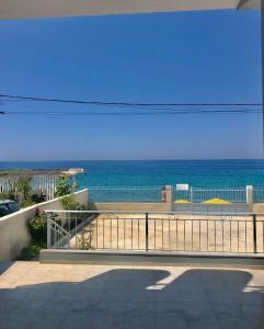 a view of the ocean from the balcony of a house at Villa Denny in Borsh +20 photos