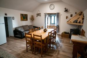 a kitchen and living room with a wooden table and chairs at Refúgio Nariz do Mundo (Casa do Meio) in Cabeceiras de Basto
