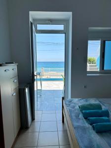 a bedroom with a bed and a view of the ocean at Villa Denny in Borsh