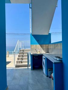 a blue kitchen with a view of the ocean at Villa Denny in Borsh