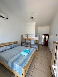 a bedroom with a bed and a bunk bed at Villa Denny in Borsh