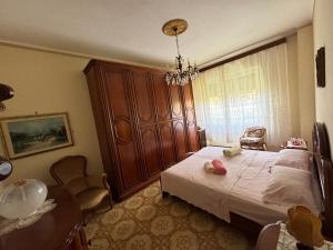 een slaapkamer met een groot bed en een kroonluchter bij Appartamento Marilyn in Levanto +15 foto's