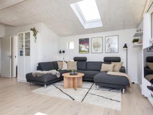 a living room with a couch and a table at 6 person holiday home in Lemvig in Lemvig