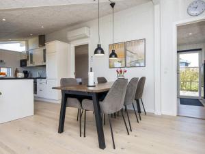 a kitchen and dining room with a table and chairs at 6 person holiday home in Lemvig in Lemvig