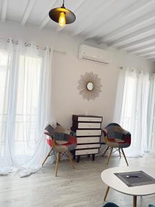a living room with two chairs and a dresser at Piso en el corazón de Alicante in Alicante