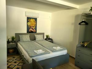 a bedroom with a bed and a painting on the wall at Dream Lake in Palić