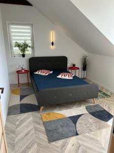 a bedroom with a bed with two pillows on it at B-Home in Göd