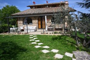 a stone path in front of a house at mikipongTWO in Montepulciano