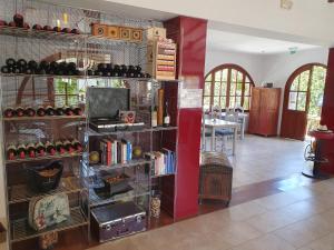 a room with a shelf filled with wine bottles at Hostal Mi Campaña in Denia