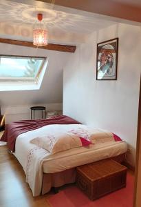 Schlafzimmer mit einem Bett, einem Fenster und einem Kronleuchter in der Unterkunft Doubs Séjour - Chambres et petits déjeuners in Verdun-sur-le-Doubs