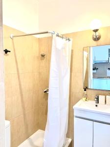 a bathroom with a shower curtain and a sink at Alcântara Studio 15 in Lisbon