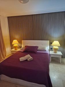 a bedroom with a bed with a robe on it at Vila Lavanda in Playa de las Americas