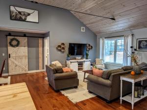 a living room with two couches and a barn door at Bar Harbor Hikers Dream in Bar Harbor