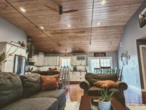 a living room with two couches and a kitchen at Bar Harbor Hikers Dream in Bar Harbor