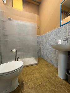 a bathroom with a toilet and a sink at Ostello Bellavita in Castelnuovo di Garfagnana