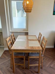 a dining room table with chairs and a chandelier at #W33 in Warsaw