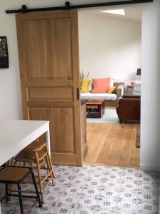 a door leading into a living room with a couch at Maison idéalement située à Versailles in Versailles