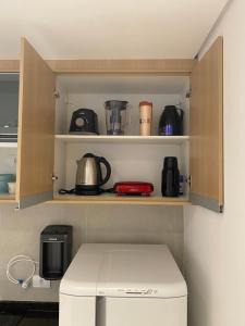 a kitchen with a cupboard filled with appliances at Fabio Av Paulista in São Paulo