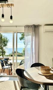 a dining room with a table and a view of the ocean at Residence Canella in Sari Solenzara