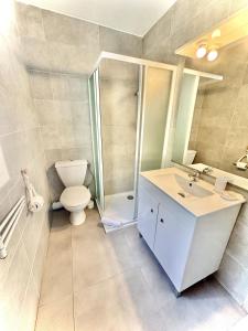a bathroom with a toilet and a sink and a shower at Residence Canella in Sari Solenzara