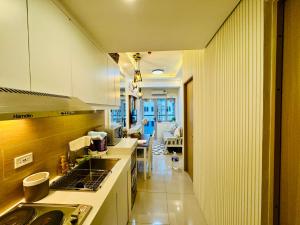 a kitchen with a sink and a stove top oven at Charming 2 BR with Amenity Views and Free Parking in Manila