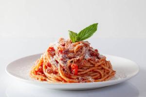 a plate of spaghetti with a green leaf on top at Hotel du Centre in Gueugnon +17 photos