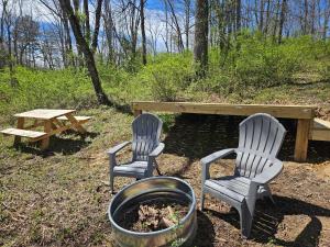 two chairs and a table and a picnic table at Black Oak Campsite at Hocking Vacations Campsites - Tent not Included in Logan