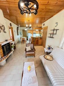 a living room with a couch and a fireplace at Rustic and Spacious House in Mytilinioí +46 photos