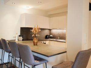 a kitchen with a table with a vase of flowers on it at Ehrenberg Apartments in Reutte