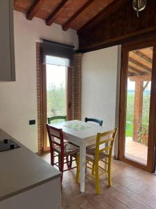 a kitchen with a table and chairs in a room at Il giardino fiorito in Santa Luce