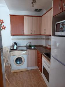 een keuken met een wasmachine en een vaatwasser bij Reina Victoria 2 bed apartment in Rojales