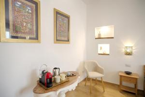 a room with a table and a chair and some pictures at Cozy guest house Downtown in Olbia