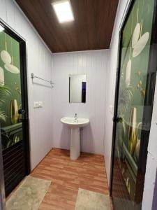 a bathroom with a sink and a mirror at The Midway Jungle Resort in Masinagudi