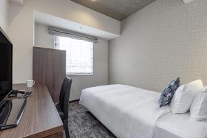 Postel nebo postele na pokoji v ubytování Tokyu Stay Suidobashi