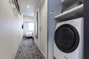 a laundry room with a washer and dryer at Tokyu Stay Suidobashi in Tokyo