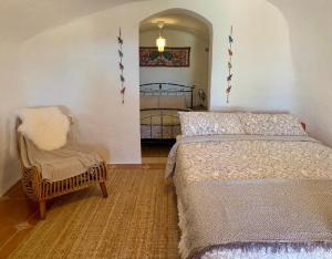 A bed or beds in a room at Cueva Romana Cave House, Clothing Optional, Adult Only
