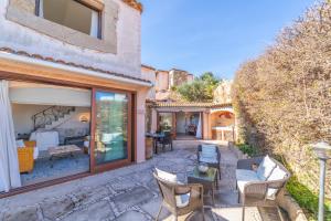 an outdoor patio with chairs and a table at Villa Ilda in Cannigione