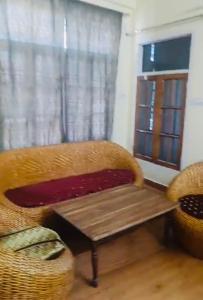 a living room with a chair and a table at Pretty park facing 2 bedroom guesthouse near lohia park Gomtinagar in Lucknow