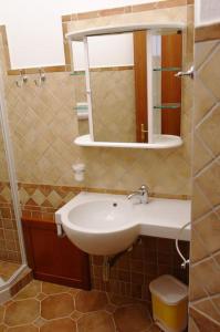 a bathroom with a sink and a mirror at Bari Sardo Le More Suite 3 in Bari Sardo +15 photos
