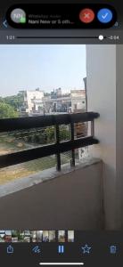a television screen with a picture of a balcony at Pretty park facing 2 bedroom guesthouse near lohia park Gomtinagar in Lucknow