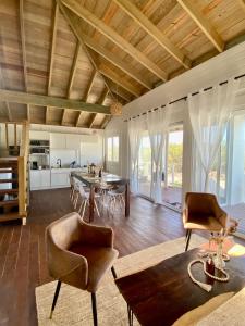 a large living room with a table and chairs at HOLBOX PUERTA DEL MAR in Holbox Island