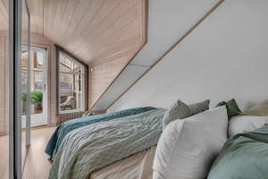 a bedroom with a bed and a large window at Apartment in Tromsø city center in Tromsø