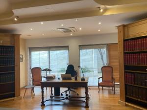 a library with a table and chairs and a laptop at AU COEUR DES LICES *** CENTRE HISTORIQUE AVIGNON in Avignon