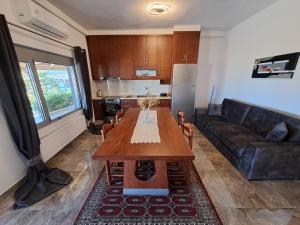 a living room with a table and a couch at Nick's Apartments Evia in Achladi