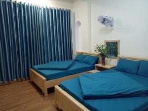 a room with two beds and a window at Anh Đào Dalat House in Da Lat