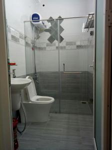 a bathroom with a shower and a toilet and a sink at Anh Đào Dalat House in Da Lat