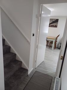 a hallway with stairs leading to a dining room at Beautiful maisonette in Leeds