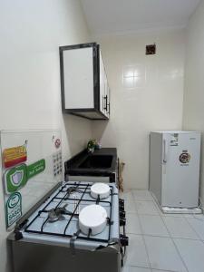 a kitchen with a stove and a refrigerator at استديو مدخل خاص وجلسات خارجية in Riyadh